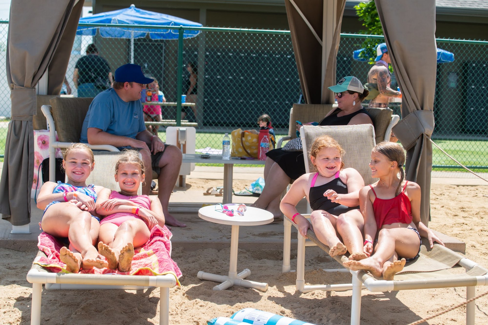Four young girls relaxing on beach chairs near their cabana at Bear Paw beach on a warm sunny day. Four young girls relaxing on beach chairs near their cabana at Bear Paw beach on a warm sunny day.