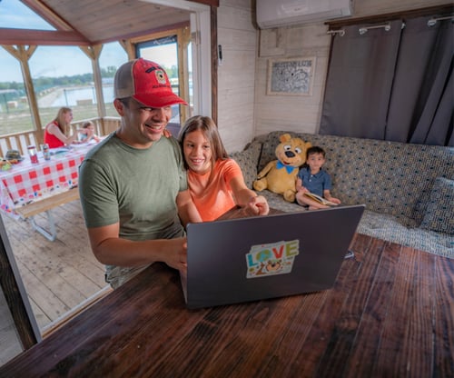 A family at Jellystone Park™ Caledonia using the complimentary WiFi available at the campground. A family at Jellystone Park™ Caledonia using the complimentary WiFi available at the campground.