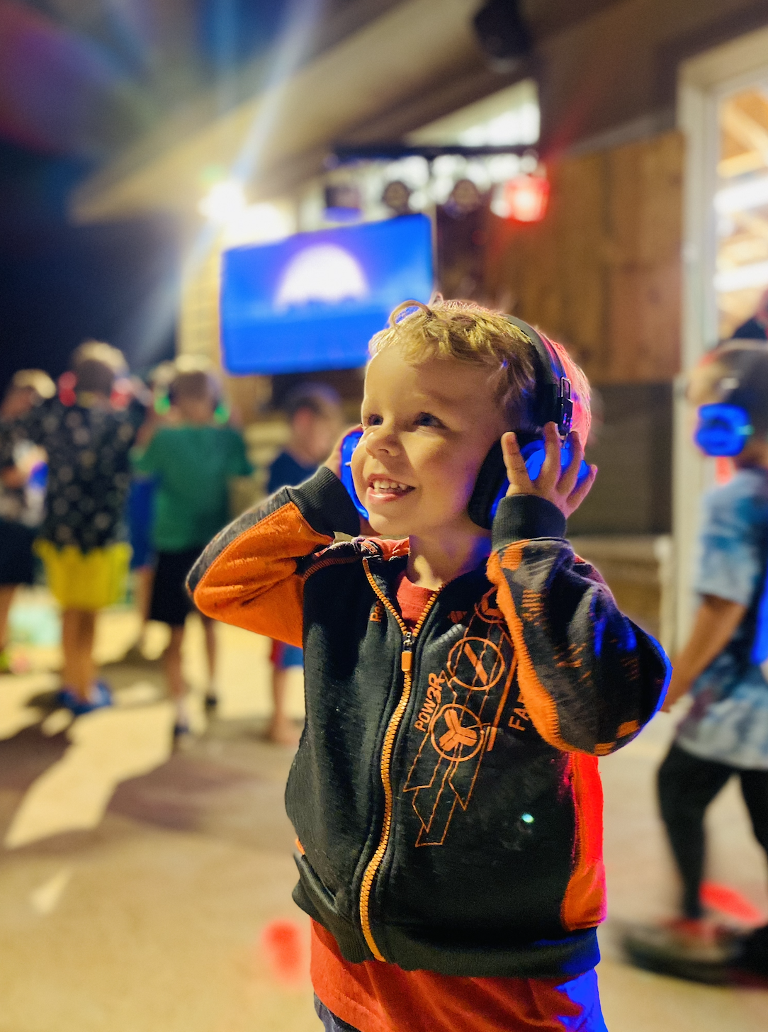 Young boy listens to music during silent disco at Bear Paw Adventure Park.